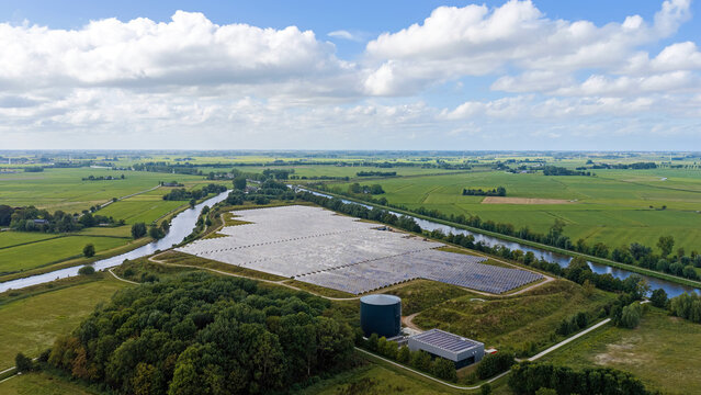 Aerial view of the solar thermal park in Dorkwerd ,Groningen, the Netherlands, showing large fields of solar panels and a circular thermal storage tank