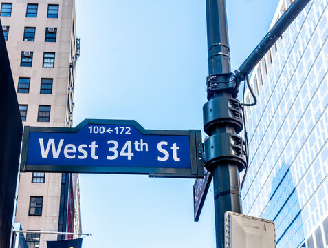 West 34th Street sign against a blue sky in Manhattan