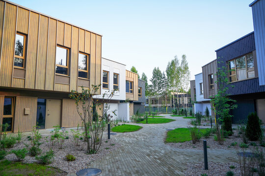Modern townhouses exterior. Apartments low-rise buildings. Two-story townhome apartments in nature . Modern townhouse in suburban area. New duplex apartment building in sustainable enviroment. 