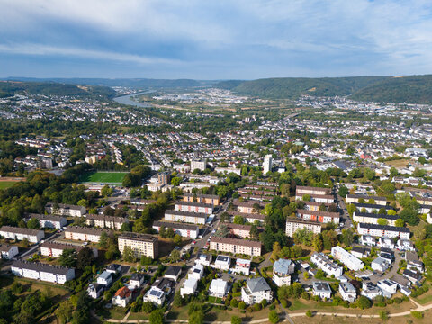 Aerial view of the historic city of Trier in the Moselle Valley, featuring residential neighborhoods, green spaces, and the Mosel river in Trier, Rhineland-Palatinate, Germany.