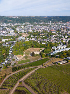 Aerial view of the historic city of Trier featuring the ancient Roman amphitheater, vineyards, and dense urban landscape with historic architecture. Trier, Rhineland-Palatinate, Germany.