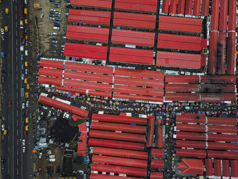 Aerial view of Agege market with rows of vibrant red rooftops and busy pedestrian walkways in Lagos, Lagos, Nigeria.