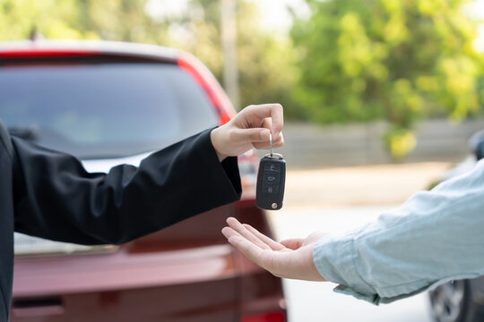 lease, rental car, sell, buy. Dealership manager send car keys to the new owner. Sales, loan credit financial, rent vehicle, insurance,  renting, Seller, dealer, installment, car care business