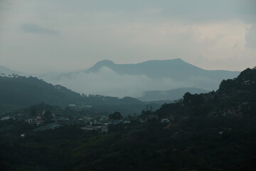 Fototapeta premium Clouds covering Elephant Mountain at sunset in Da Lat, Vietnam