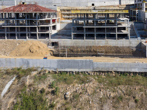 Aerial view of a large construction site featuring concrete building frames, steel reinforcement structures, and excavated earthworks in Bursa, Bursa, Turkiye.