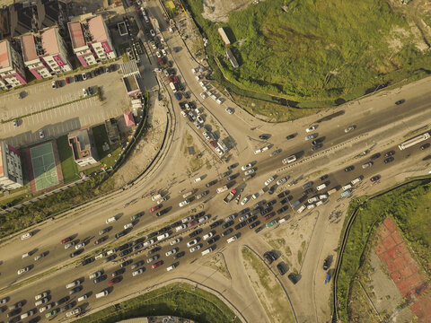 Aerial view of a busy road intersection with heavy traffic flow and urban development in Lekki, Lagos, Nigeria.