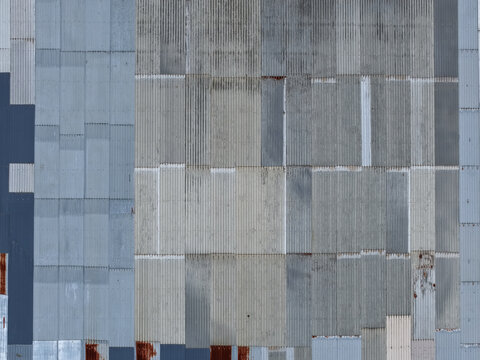 Melbourne, VIC, Australia - 25 September 2026: Aerial view of corrugated metal panels on an industrial building roof, showing weathered textures, rust spots, and overlapping steel sheets.