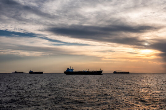 Crude oil tankers in the sea at sunset. Oil and gas industry. Tankers crude oil carrier ship designed for transporting grude oil