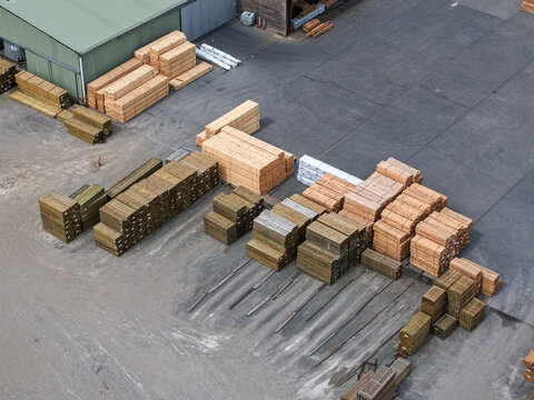 Melbourne, VIC, Australia - 25 September 2026: Aerial view of stacks of timber and lumber stored in a yard at a wood processing facility.