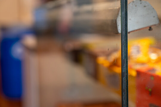 Selective focus on glass edge at concession stand with rows of candy at old movie theatre