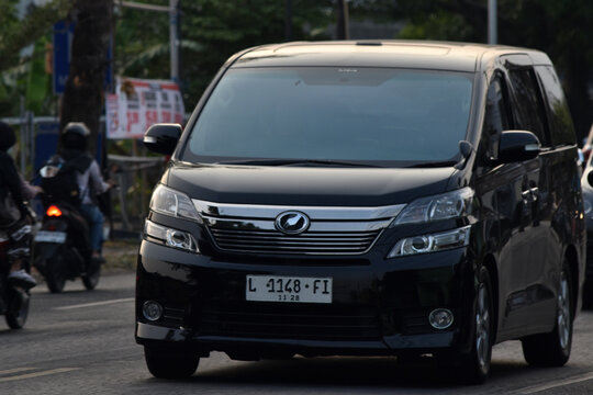 Front perspective shot of a black Toyota Vellfire 
