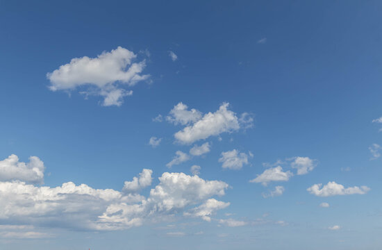 Sky replacement blue sky and small puffy white clouds