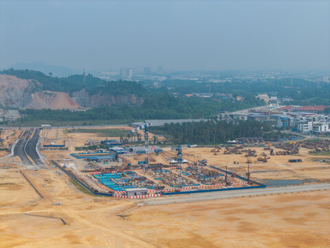 Bukit Tambun, Penang, Malaysia - 25 September 2026: Aerial view of a large construction area with cranes, heavy machinery, and earthworks in a developing landscape.