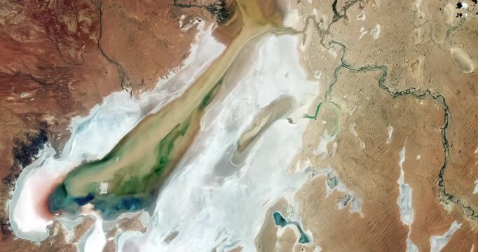 Bird's eye view on salt marsh, white salt deposits. Camera is zooming in. Animation based on image by NASA