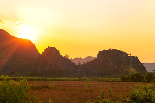 Picturesque karst landscape near Tam Coc village at sunset. Ninh Binh, Vietnam.