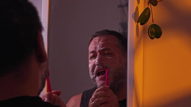 a man brushes his teeth and sings