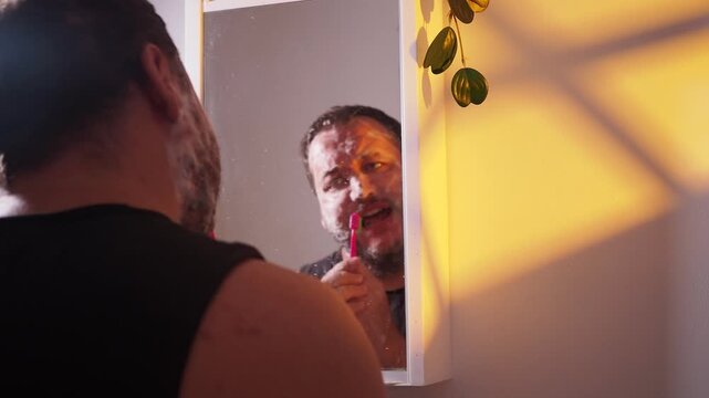 a man brushes his teeth and sings