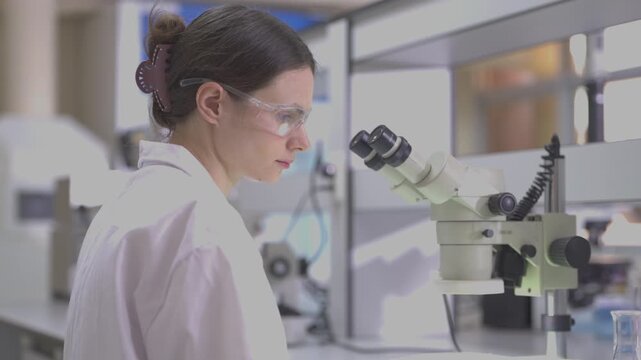 Science, microscope and study with of a woman in a laboratory for research and innovation. Medical, pharmaceutical sample and a young scientist in a lab for development, discovery or breakthrough