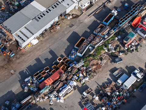 Melbourne, VIC, Australia - 22 September 2026: Aerial view of industrial recycling facility with various metal containers, trucks, and factory buildings in Kilsyth.