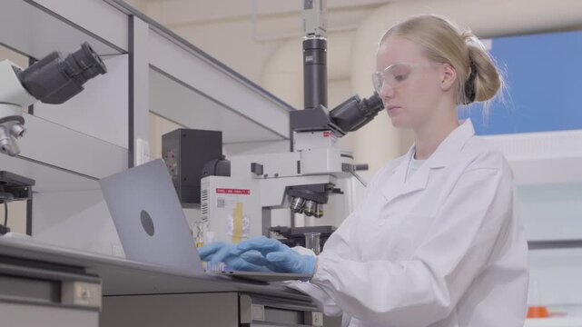 Woman, scientist and review with tablet in lab for medical research, experiment and botany. Person, online and reading report for investigation, study genetics and information for ecology innovation