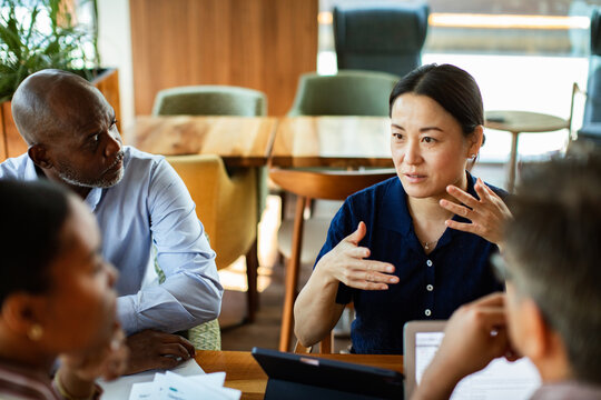 Woman leading discussion with colleagues in office