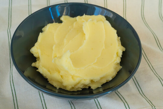 Mash potato in black bowl closeup