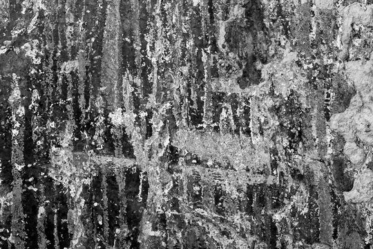 A black metal background with scratches and a rough, distressed texture.
