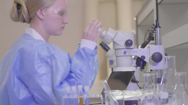 Science, microscope and study with of a woman in a laboratory for research and innovation. Medical, pharmaceutical sample and a young scientist in a lab for development, discovery or breakthrough