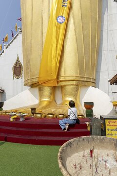 Feet of a 32 metre high standing Buddha statue, Wat Intharawihan, Bangkok, Thailand