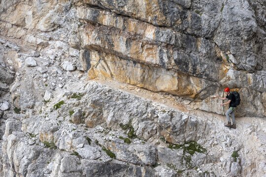 Hikers on the Via Ferrate Benini via ferrata on a cliff, Brenta Mountains, Parco Naturale Brenta-Adamello, Trentino, Italy