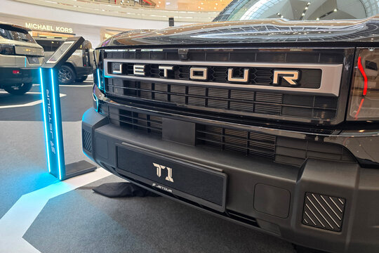 Penang, Malaysia - Sep 25, 2026: Front grille, bumper, and badge detail of a Jetour T1 SUV on display inside a shopping mall roadshow.