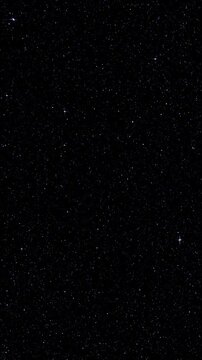 Smoothly Turning Space Background with Star Glimmers. Twinkling stars shift through smoothly rotating starfield. This space background features pointed glimmers against deep dark sky.
