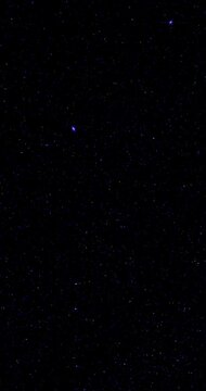Nearly black screen with sparse blue digital noise flickering subtly. Tiny scattered pixels create restrained abstract background with quiet minimal mood.