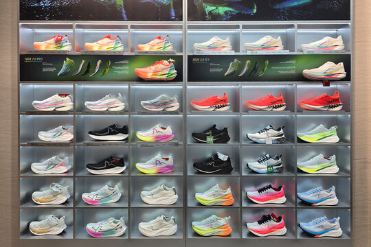 Penang, Malaysia - Sep 26, 2026: Wall display inside an Xtep retail store featuring rows of high-performance running shoes, including 160X and 360X series sneakers, arranged on illuminated shelves.