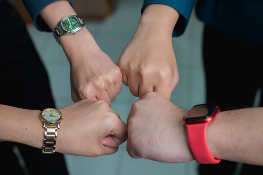 Two international businesswomen shaking hands, symbolizing a successful meeting or negotiation, reaching a mutual agreement, and signifying cooperation and the finalization of a deal or business partn