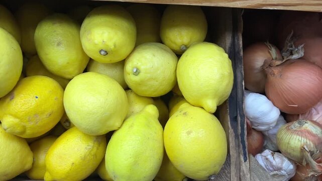 Produce Market Display &ndash; Close-Up Yellow Lemons, Brown Onions and White Garlic