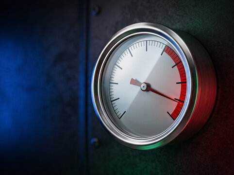 round pressure gauge measures parameters in dangerous red zone on dark background with blue and red lighting reflecting the concept of critical level and risk