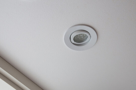 Modern recessed spotlight integrated into a clean white ceiling surface. The energy-efficient LED downlight features an adjustable gimbal ring to direct light where needed.