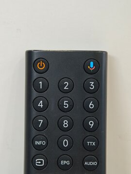 Black smart TV remote control keypad with voice control and number buttons