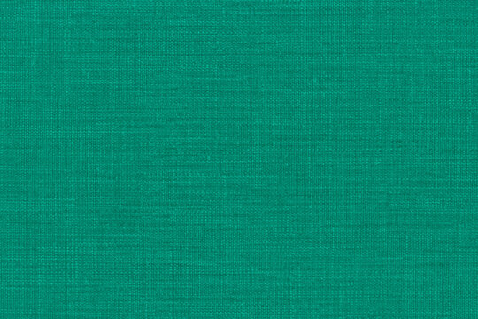 Turquoise fabric texture with visible woven fibers and subtle tonal variations, ideal for textile backgrounds, graphic design, decor and creative projects.