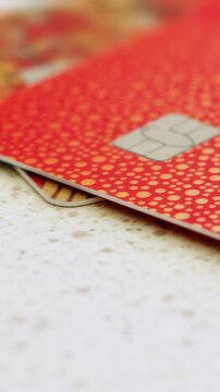 Macro close up shot of a credit card. Extreme close up of debit cards with the EMV microchip. Concept of banking, finance, and secure electronic payments. Vertical video.