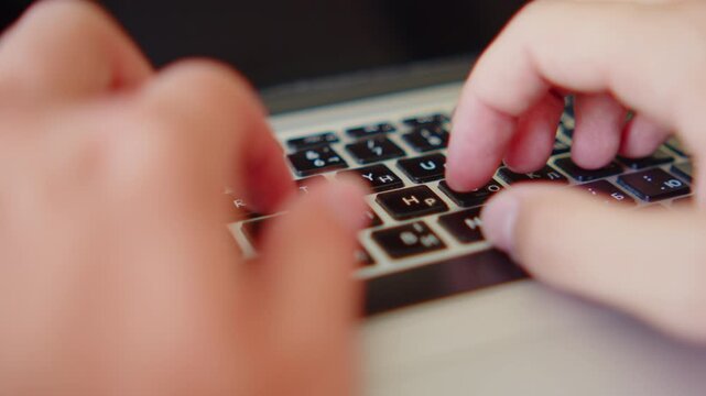 Man fast typing text on a keyboard. Macro shot of a person fast typing on a laptop keyboard.