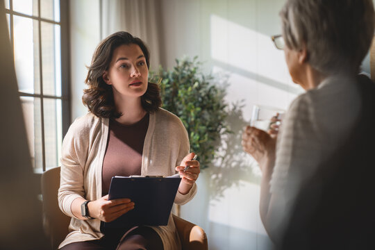 Empathetic Female Counselor Listening to Senior Client