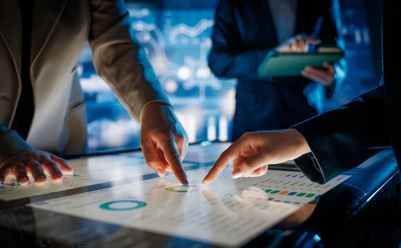 Business Team Collaborating on Interactive Touchscreen Table in Futuristic Office