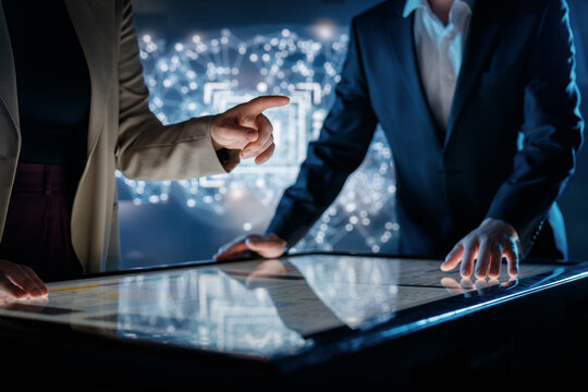 Business Team Collaborating on Interactive Touchscreen Table in Futuristic Office