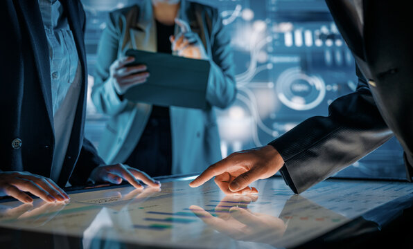 Business Team Collaborating on Interactive Touchscreen Table in Futuristic Office