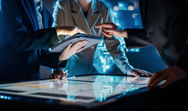 Business Team Collaborating on Interactive Touchscreen Table in Futuristic Office