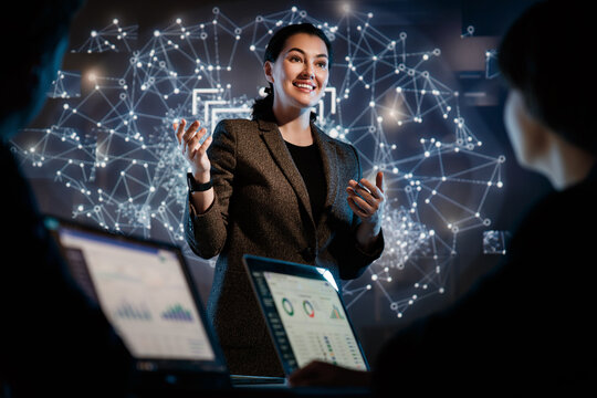 Confident Businesswoman Presenting Data Science Insights with Futuristic Network Visualization