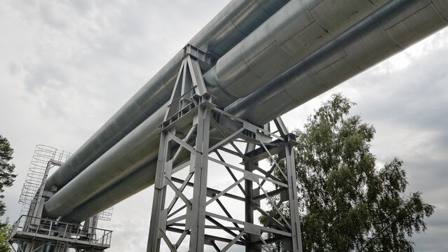 a pipeline on a metal support against a gray sky