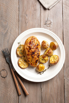 Oven roasted lemon garlic chicken and baby potatoes on plate